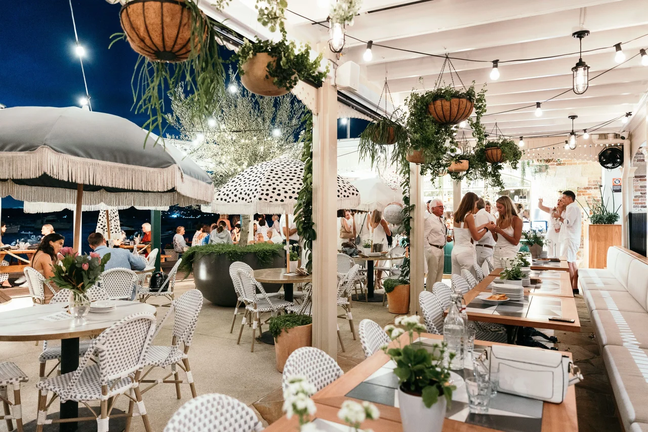 Doyle's dining terrace with hanging plants and illuminated outdoor seating